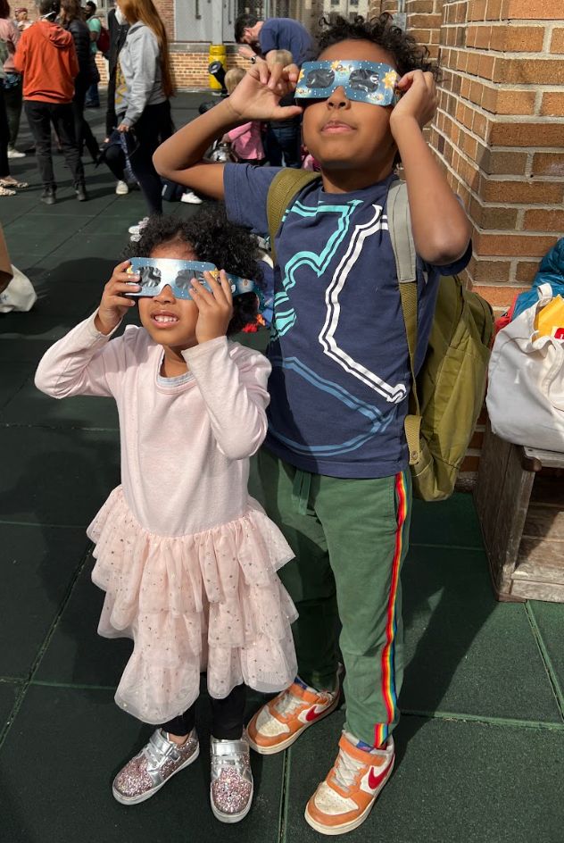 The author's children looking at the eclipse in 2024.