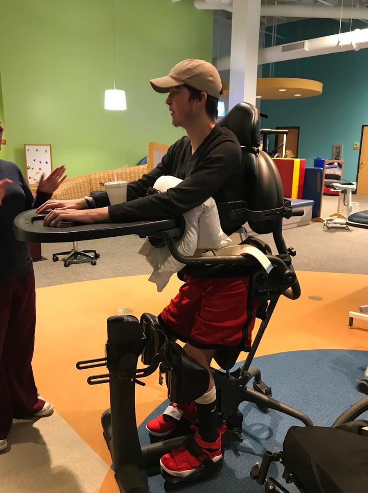 Mitchell in his stander. “This was at PT when he was doing inpatient rehab in November 2018, after a relapse caused him to have to leave St. Louis University during his freshman year,” the author writes. “He was at an inpatient rehab facility for two months before coming home.”