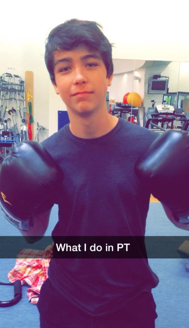 Mitchell wearing boxing gloves. “This is a snapchat Mitchell sent during a physical therapy session,” the author writes. “He was in PT from 2012 to 2019, varying from every other week up to three to five days a week depending on how he was doing. This was probably around 2017, when he was walking with a cane and his physical therapist was trying to find activities to engage him in PT.”