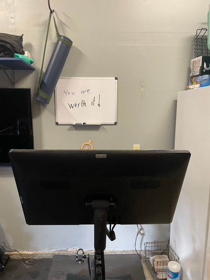 A garage workout station. Where before the whiteboard used to read, "Make it worth it!" the author's husband erased and rewrote it to now say, "You are worth it!"