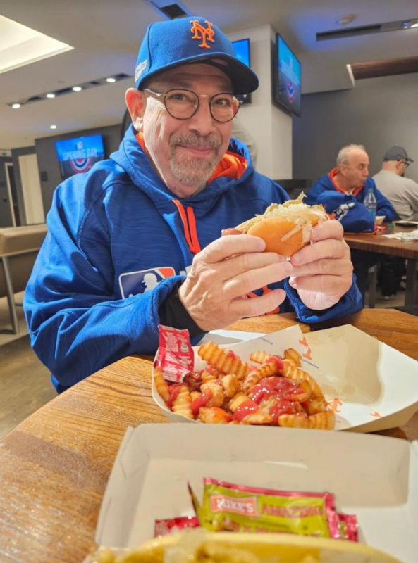 The author's dad chowing down on Opening Day 2024, at one of the last games he got to attend in person.